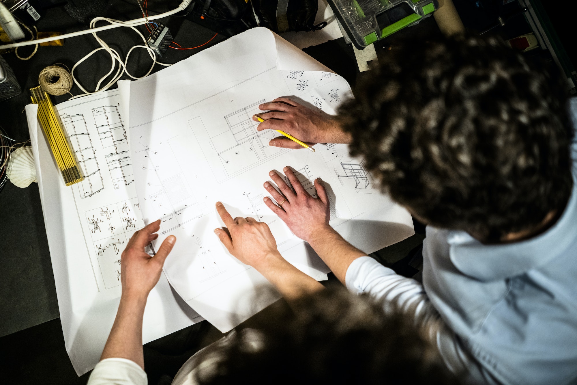 Two colleagues working on a construction plan together